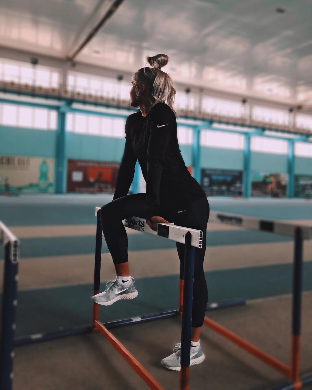 Ксения Трибунова в черном костюме в легкоатлетическом зале