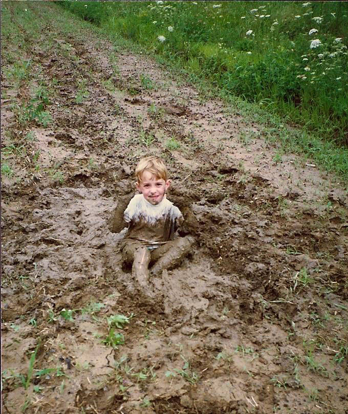 Ребенок сидит в грязи