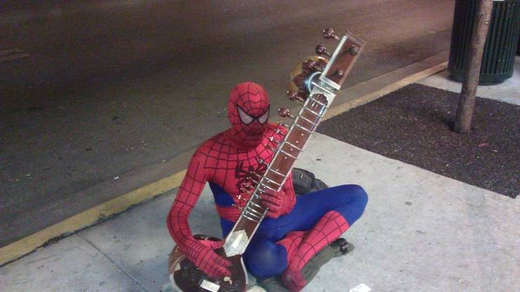 Человек-паук играет на музыкальном инструменте