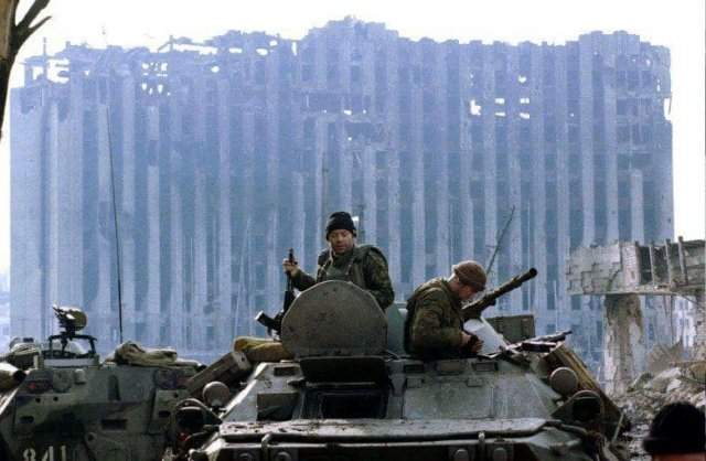 Российские военные на фоне разрушенного Президентского дворца в Грозном, январь 1995 года.